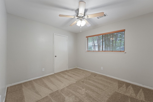 unfurnished room with baseboards, carpet, a ceiling fan, and visible vents