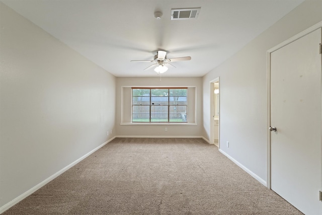unfurnished room featuring baseboards, a ceiling fan, carpet flooring, and visible vents