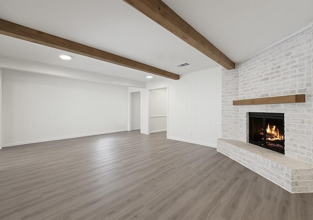 12510 Deep Spring Ln, Houston, TX 77077 - unfurnished living room featuring beamed ceiling, wood finished floors, a fireplace, baseboards, and recessed lighting