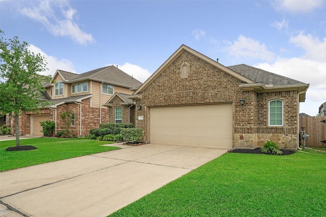 view of front of home featuring concrete driveway, brick siding, a front yard, and a garage