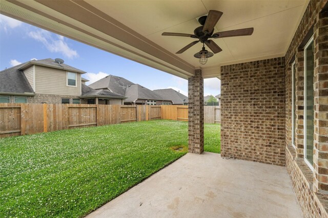 view of yard with a patio, a ceiling fan, and a fenced backyard