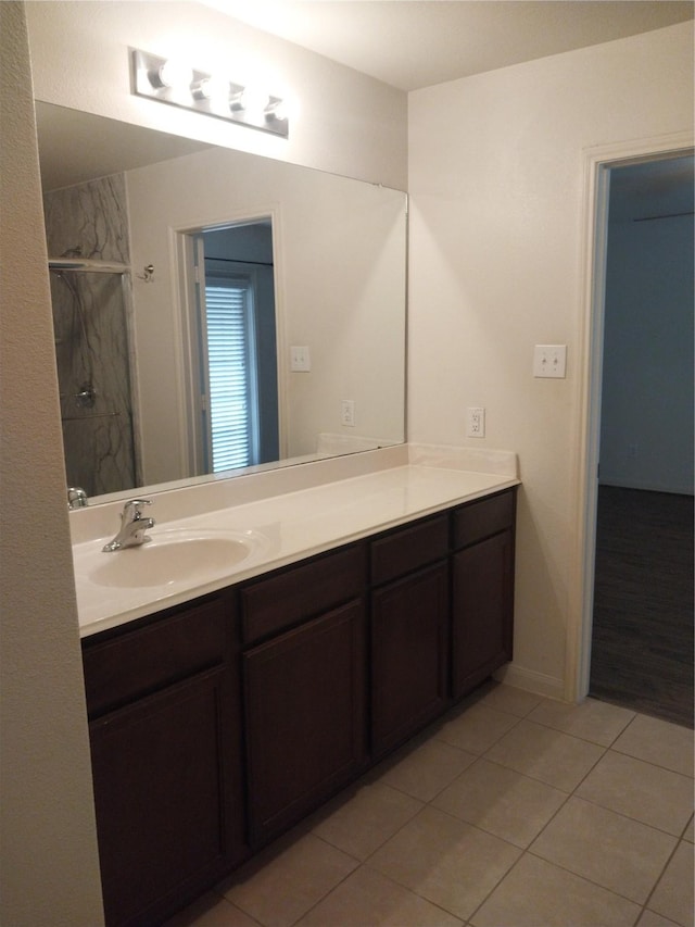 bathroom with vanity, tile patterned floors, and a stall shower