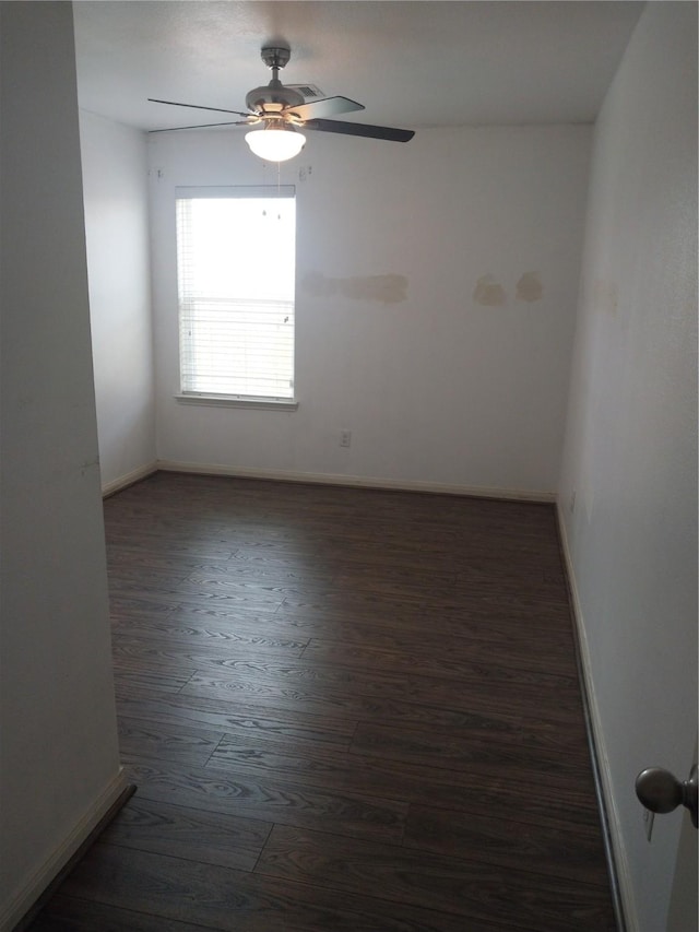 empty room with a ceiling fan, baseboards, and wood finished floors