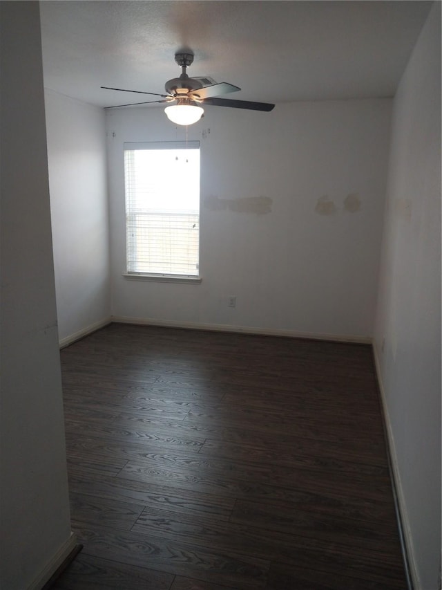 unfurnished room featuring baseboards, a ceiling fan, and wood finished floors