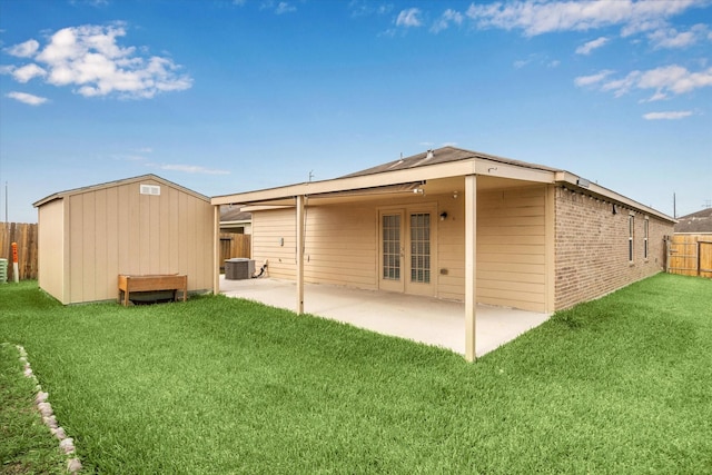4910 Pacific Ridge Ln, Rosenberg, TX 77469 - back of house featuring a patio, brick siding, central AC, and an outbuilding