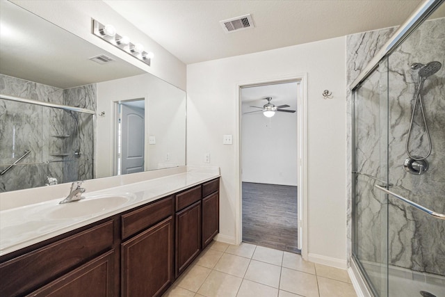 4910 Pacific Ridge Ln, Rosenberg, TX 77469 - bathroom featuring a marble finish shower, tile patterned flooring, vanity, ceiling fan, and baseboards