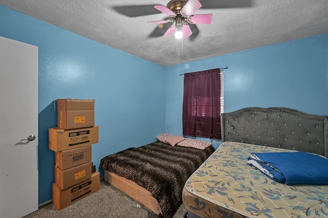 carpeted bedroom with ceiling fan and a textured ceiling