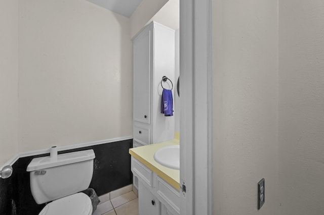 bathroom featuring toilet, tile patterned flooring, and vanity