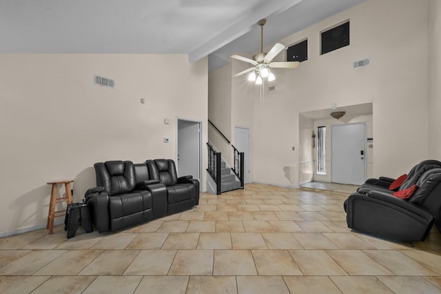 living area with visible vents, a ceiling fan, high vaulted ceiling, and stairway