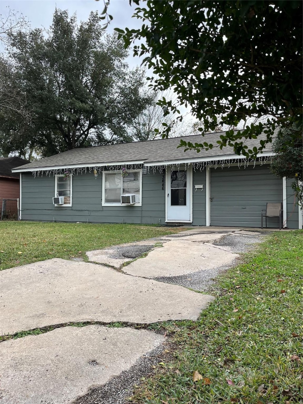 3446 Bacon St, Houston, TX 77021 - ranch-style house with gravel driveway, cooling unit, a front lawn, and a garage