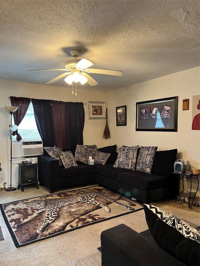 living room featuring a ceiling fan, a textured ceiling, carpet, and cooling unit