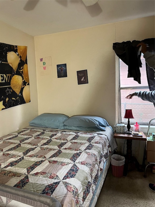 bedroom with a ceiling fan and carpet flooring