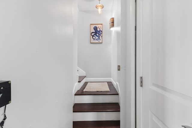 staircase featuring baseboards