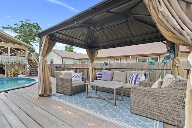 wooden terrace featuring a gazebo, fence, stairs, and an outdoor hangout area