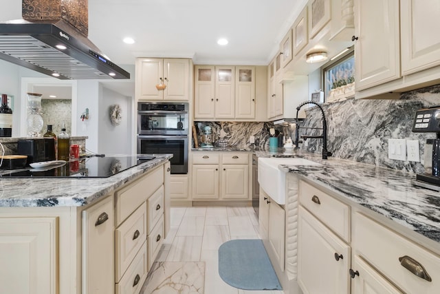 kitchen with decorative backsplash, marble finish floor, a sink, exhaust hood, and stainless steel appliances