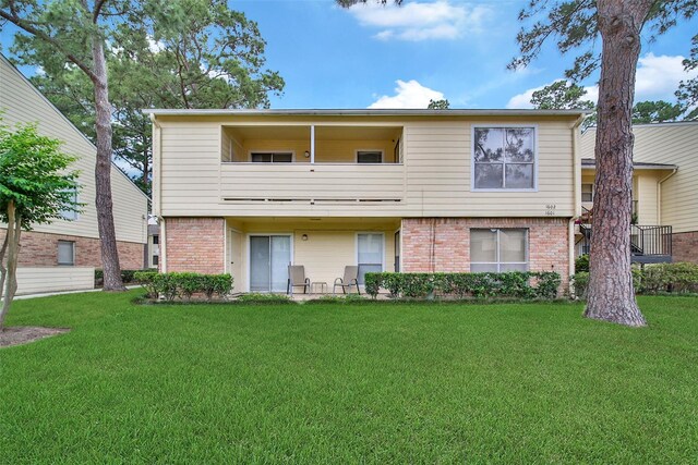 14515 Wunderlich Dr Unit 1602, Houston, TX 77069 - rear view of property with a lawn, brick siding, and a balcony