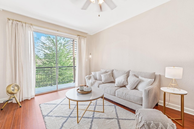 living room with baseboards, ceiling fan, and wood finished floors