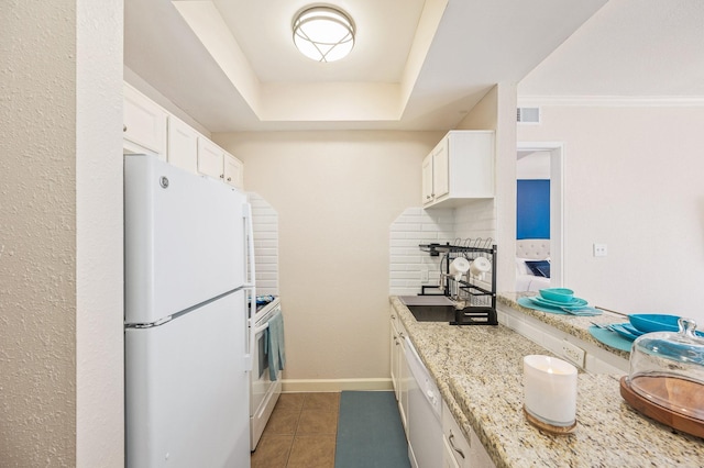 kitchen featuring visible vents, white appliances, white cabinetry, light stone counters, and light tile patterned floors