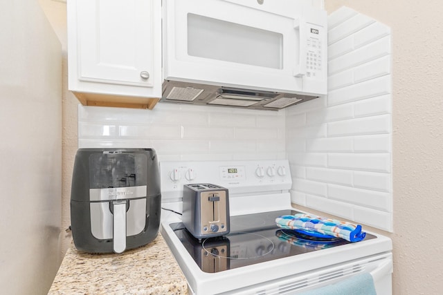 kitchen featuring light countertops, white cabinetry, backsplash, and white appliances