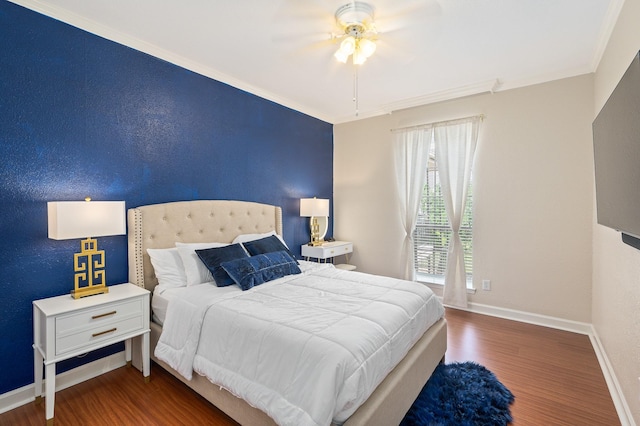 bedroom with crown molding, baseboards, a ceiling fan, and wood finished floors
