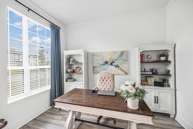 office area featuring baseboards, ornamental molding, and light wood-style flooring