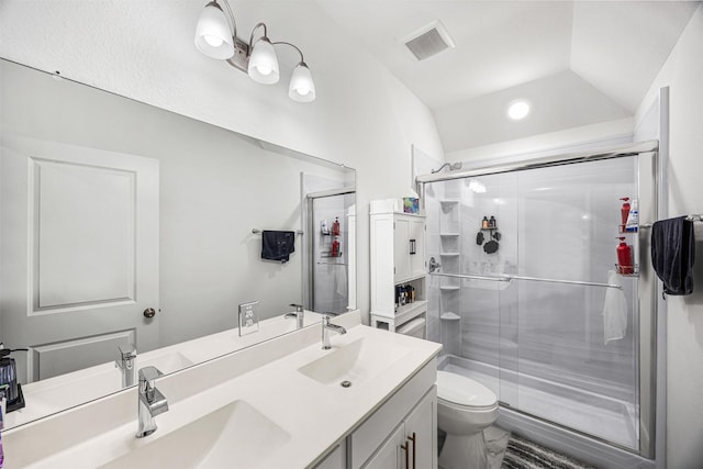 bathroom featuring visible vents, a sink, a stall shower, and toilet