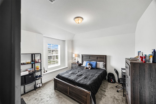 carpeted bedroom with baseboards and vaulted ceiling