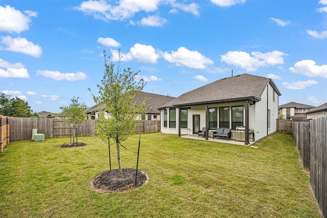 rear view of house with roof with shingles, an outdoor hangout area, a fenced backyard, a patio, and a yard
