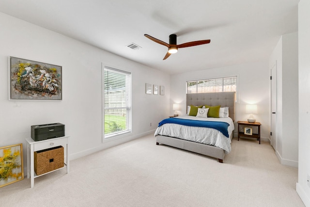 bedroom featuring baseboards, a ceiling fan, carpet flooring, and visible vents