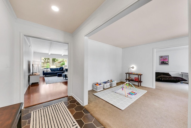 interior space with baseboards, ornamental molding, and dark carpet