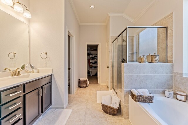 full bathroom with a garden tub, a shower stall, vanity, a spacious closet, and ornamental molding