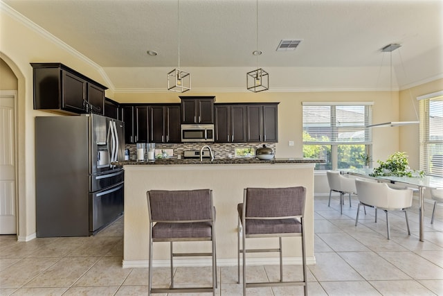 kitchen with light tile patterned floors, appliances with stainless steel finishes, backsplash, and visible vents