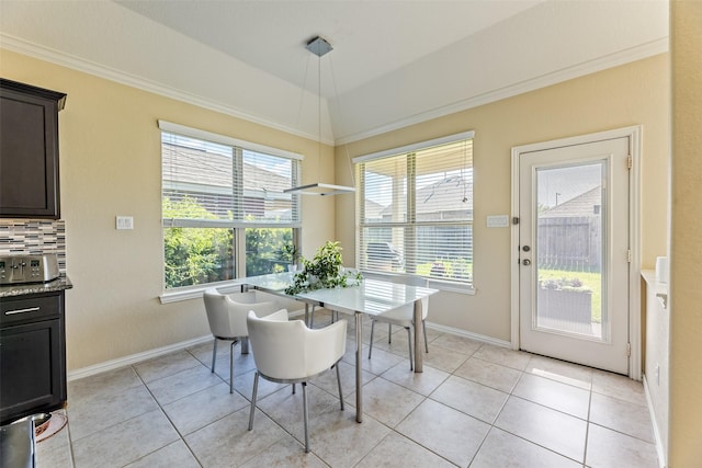 dining room with baseboards, crown molding, and light tile patterned floors