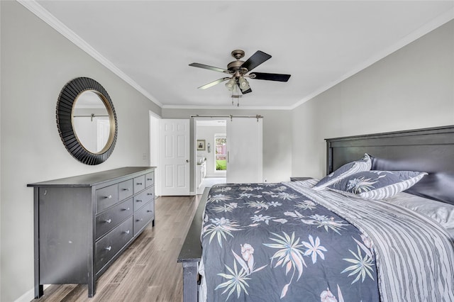 bedroom with crown molding, a ceiling fan, baseboards, and wood finished floors