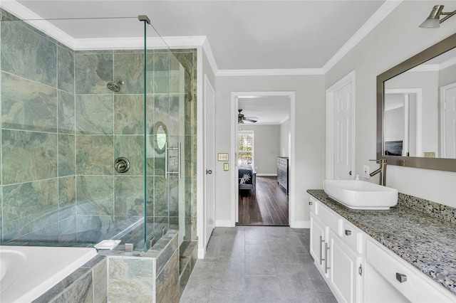 ensuite bathroom with a ceiling fan, a shower stall, vanity, baseboards, and ornamental molding