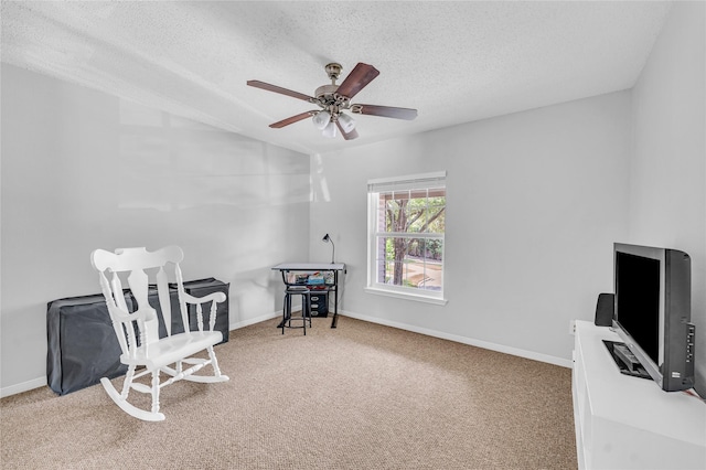 sitting room with carpet floors, a textured ceiling, and ceiling fan