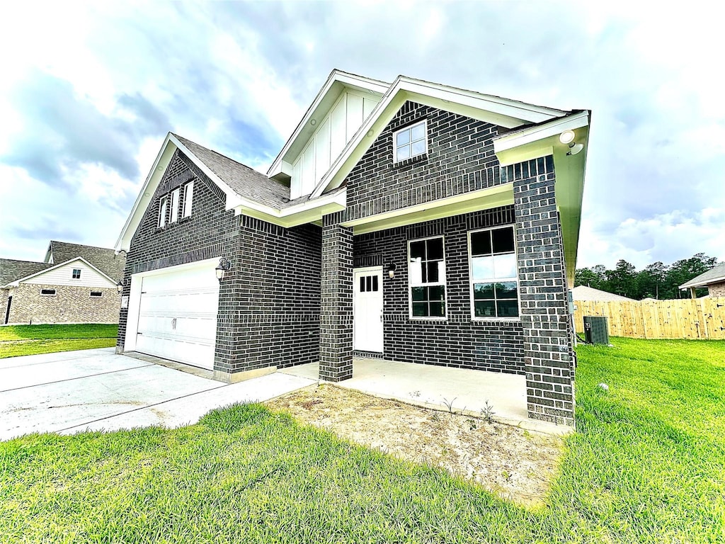 view of front of property with fence, a front lawn, brick siding, central AC unit, and driveway