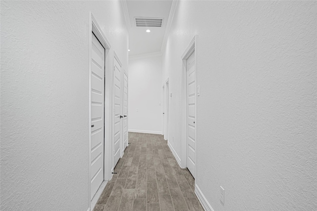123 Big Spring Dr, Anahuac, TX 77514 - corridor featuring wood finished floors, crown molding, a textured wall, recessed lighting, and baseboards