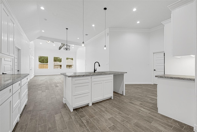 123 Big Spring Dr, Anahuac, TX 77514 - kitchen with a sink, recessed lighting, white cabinetry, a kitchen island with sink, and crown molding