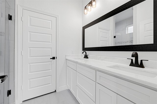 123 Big Spring Dr, Anahuac, TX 77514 - full bathroom featuring marble finish flooring, tiled shower, and double vanity
