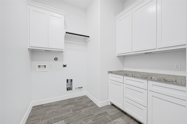123 Big Spring Dr, Anahuac, TX 77514 - laundry area featuring hookup for a gas dryer, electric dryer hookup, hookup for a washing machine, cabinet space, and baseboards