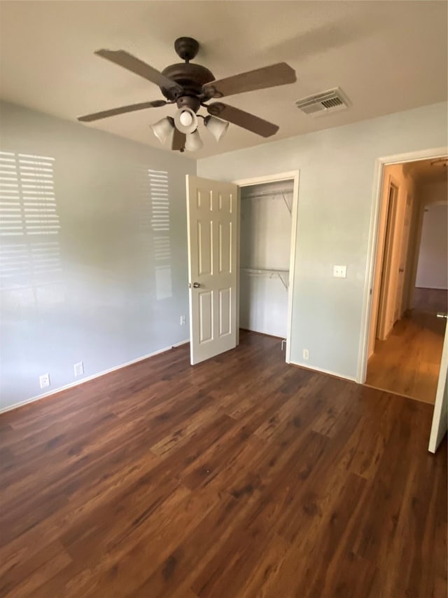 3006 Red Stag Pass, Missouri City, TX 77459 - unfurnished bedroom with ceiling fan, dark wood finished floors, baseboards, visible vents, and a closet