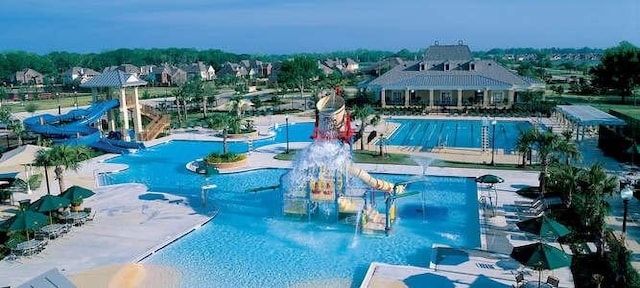 3006 Red Stag Pass, Missouri City, TX 77459 - pool with a patio, a water slide, and a water play area