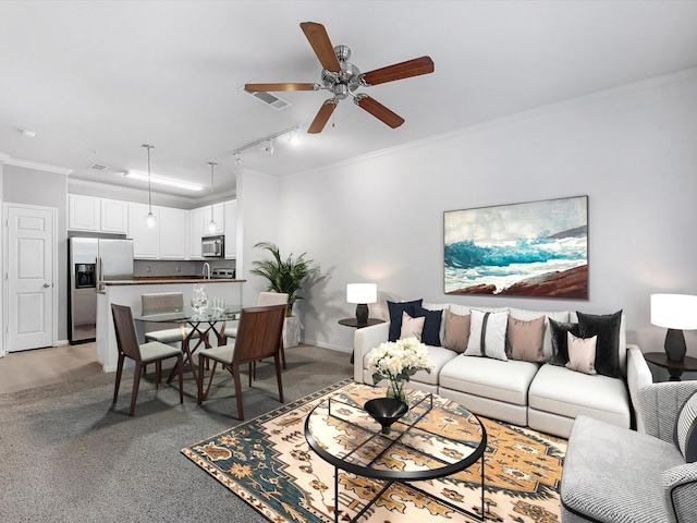 9200 Westheimer Rd Unit 1111, Houston, TX 77063 - living area with light carpet, a ceiling fan, ornamental molding, and rail lighting