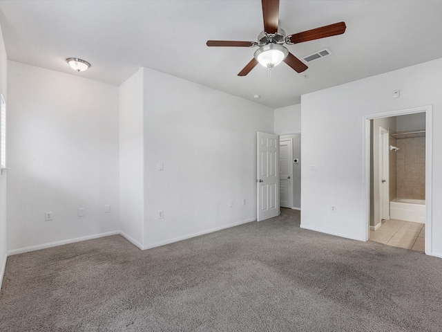 9200 Westheimer Rd Unit 1111, Houston, TX 77063 - unfurnished bedroom featuring light carpet, baseboards, ensuite bathroom, and a ceiling fan