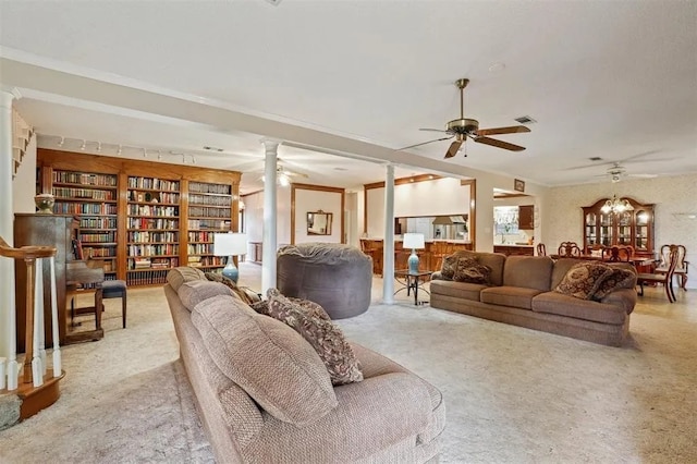 living area with a ceiling fan, decorative columns, built in features, and carpet