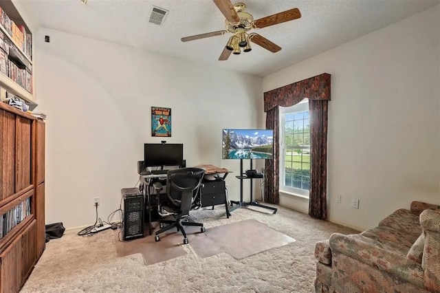 office area featuring carpet floors, baseboards, a ceiling fan, and visible vents