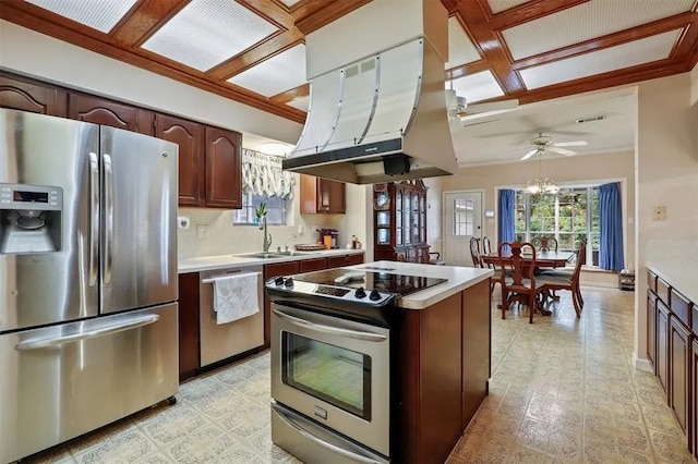 kitchen featuring light countertops, a sink, appliances with stainless steel finishes, and island exhaust hood