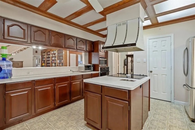 kitchen featuring crown molding, a kitchen island, range hood, light countertops, and black appliances