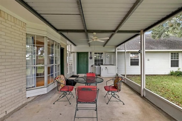 sunroom / solarium with a healthy amount of sunlight, ceiling fan, and outdoor dining space